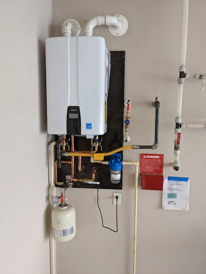 Professional plumber installing copper piping in a Marion home